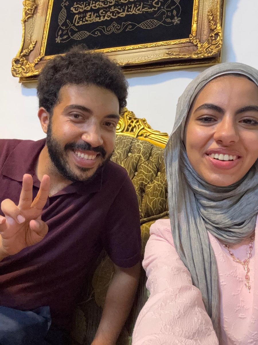 Us smiling at home on the sofa